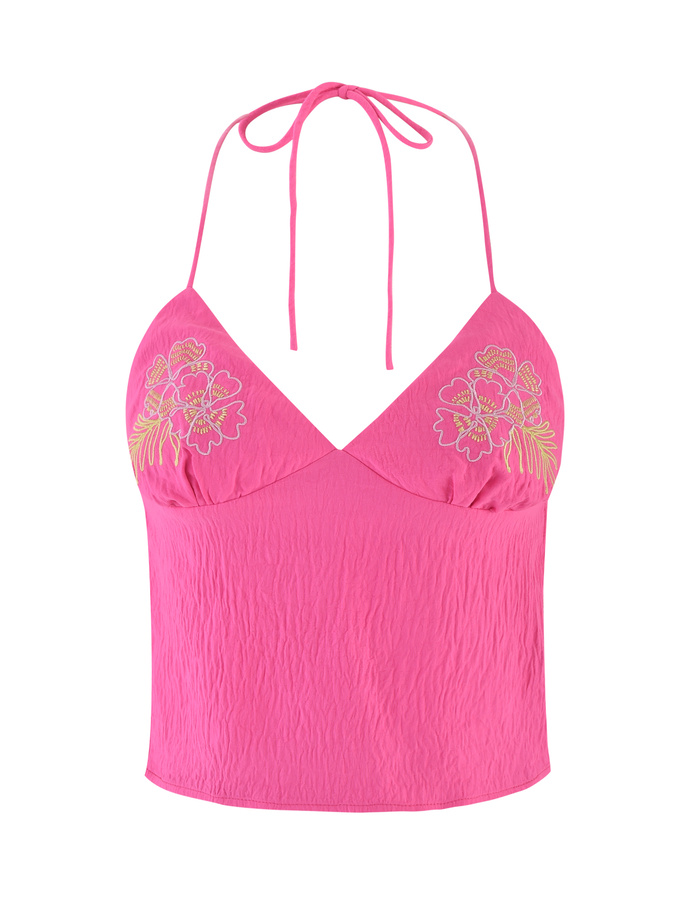 The KAELAH TOP by TIGERMIST is a hot pink halter with an open back, thin straps, floral embroidery on each chest side, and a slightly crinkled fabric texture.