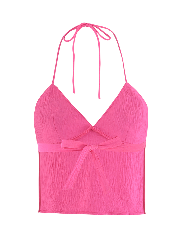 The KAELAH TOP - HOT PINK by TIGERMIST is a textured halter featuring a V-neckline, front bow under the bust, and an open back tied with thin neck straps.