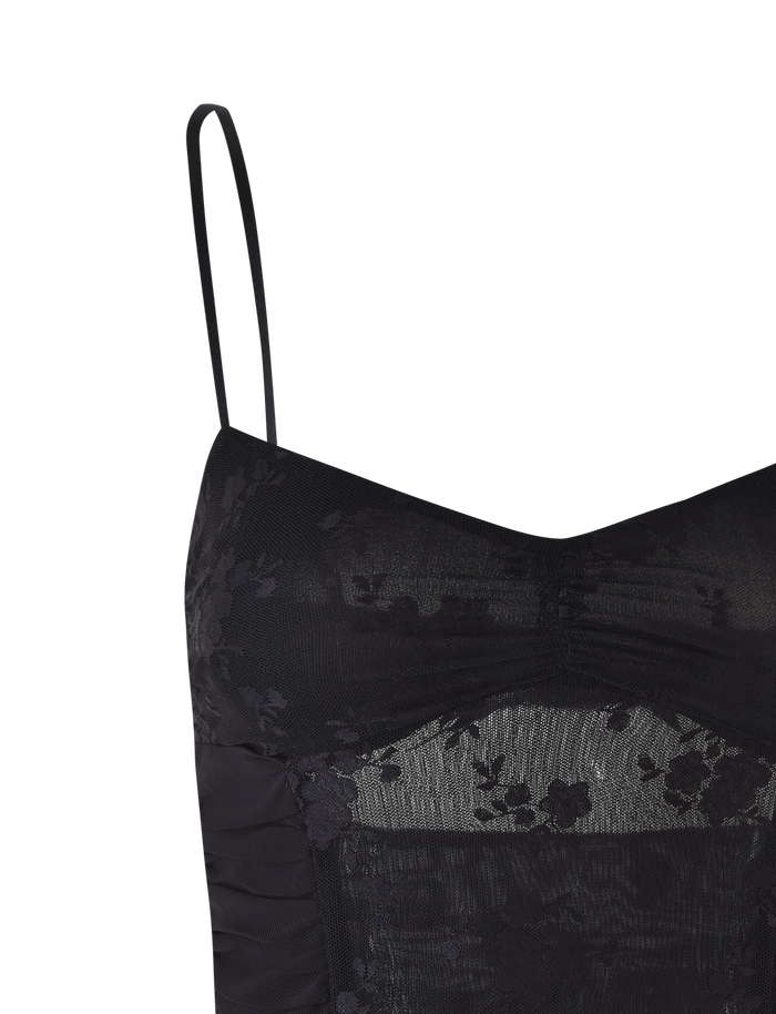A close-up of the TIGERMIST KALLIE TOP - BLACK, showcasing its black lace with floral patterns, sheer mesh panels, and thin adjustable strap.