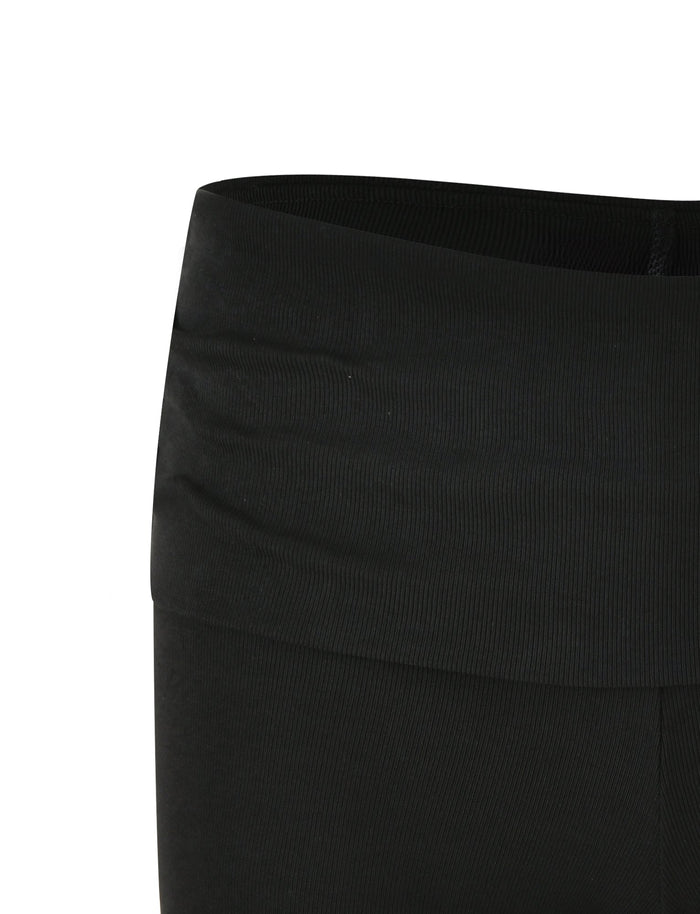 Close-up view of the waistband and upper part of TIGERMIST's KARINA RIB SHORT - BLACK leggings. The fabric appears to be stretchy, with a smooth, ribbed texture, and the waistband is designed to sit high on the waist. No visible patterns or logos are present on these leggings.