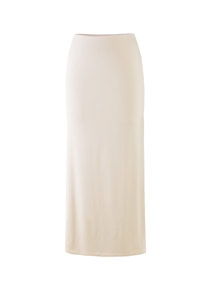 The KAROLINA JERSEY SKIRT in off white, ivory from TIGERMIST is a long, high-waisted pencil skirt made from a soft, stretchy fabric. This fitted skirt falls straight down to the ankles, creating a sleek silhouette.