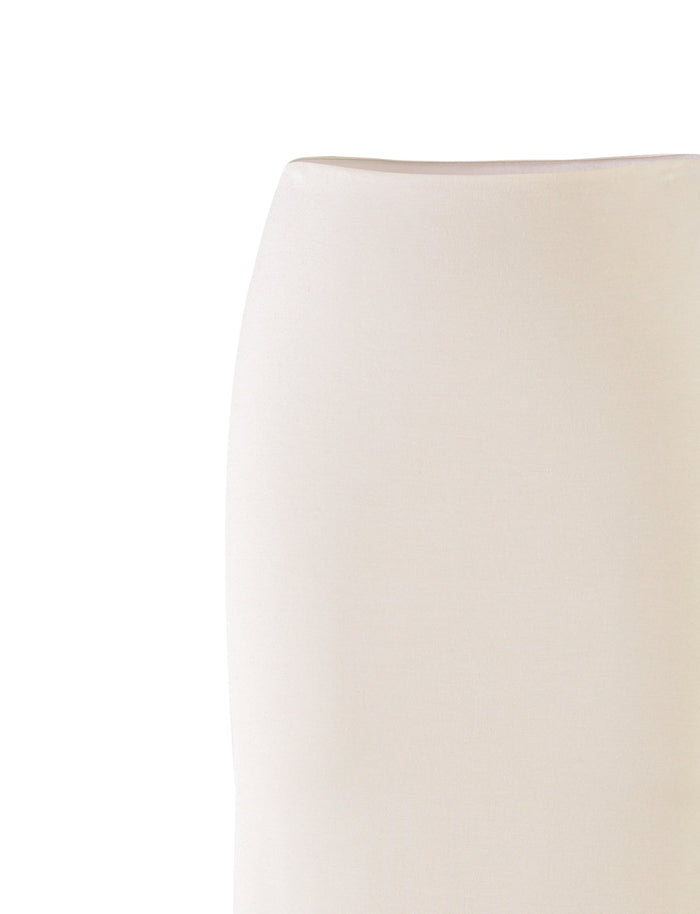 Close-up image of the cream backrest of a chair or sofa, displaying a smooth texture and minimalist fabric upholstery. The background is entirely white, highlighting the simplicity and elegance of this piece in a style that mirrors TIGERMIST's refined design sensibilities, reminiscent of their KAROLINA JERSEY SKIRT in WHITE.