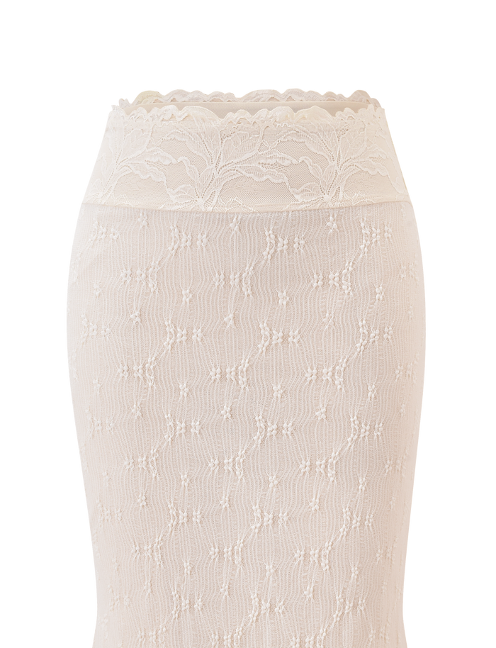 Close-up of the TIGERMIST KATERINA MIDI SKIRT in cream, featuring white stretch lace with floral and geometric patterns and a scalloped waistband, displayed against a plain white background.