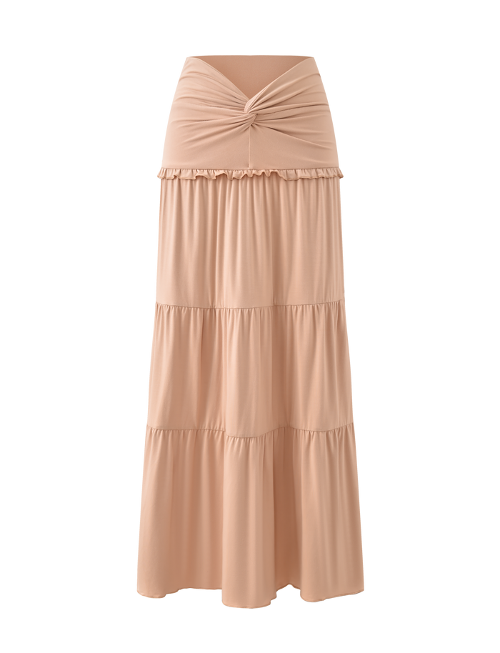 The TIGERMIST KATYA MAXI SKIRT in tan features a wide waistband, gathered knot detail, and three tiered sections with subtle ruffle seams. Shown on a plain white background.