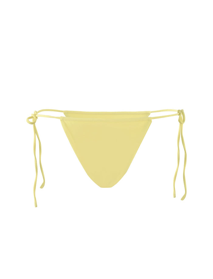Image displaying the KHESSA BIKINI BOTTOM - YELLOW: LEMON by TIGERMIST, featuring adjustable tie sides. The design is simple and minimalist with a solid yellow color, free from patterns or additional embellishments. The long ties allow for a customized fit.