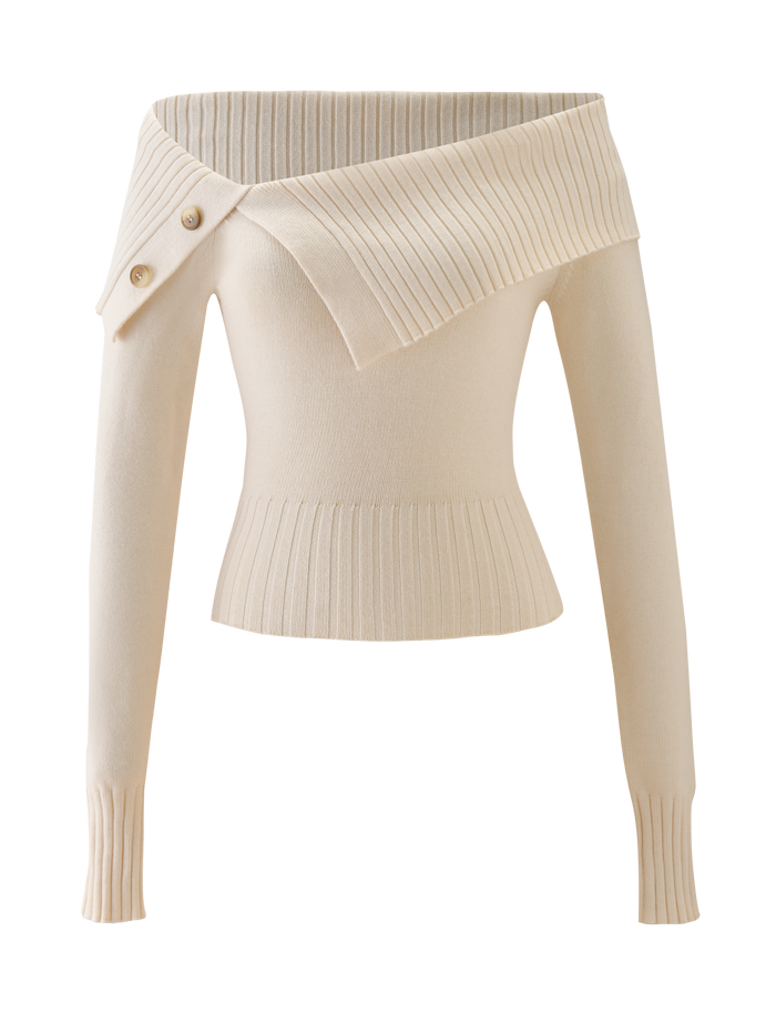 The KIERA JUMPER by TIGERMIST is a cream off-shoulder knit sweater with long sleeves, ribbed waist and cuffs, an asymmetrical neckline, and decorative side buttons.