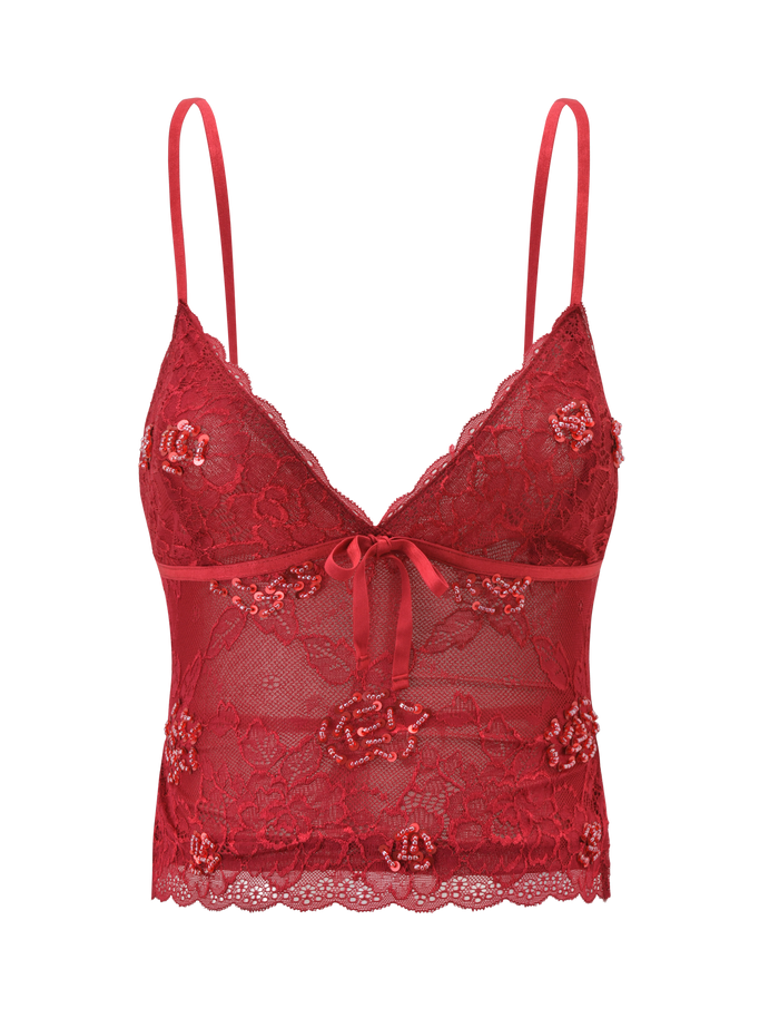 The KIRRA BEADED SEQUIN LACE TOP by TIGERMIST is a red, semi-sheer lace top with thin straps, floral patterns, scalloped hem, center bow, and delicate sequin detailing for a feminine and elegant look.