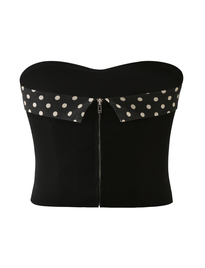 The TIGERMIST KITTIE 2.0 BUSTIER - BLACK is a strapless bustier top in stretch suiting fabric with a front zipper and a folded black and white polka dot collar.