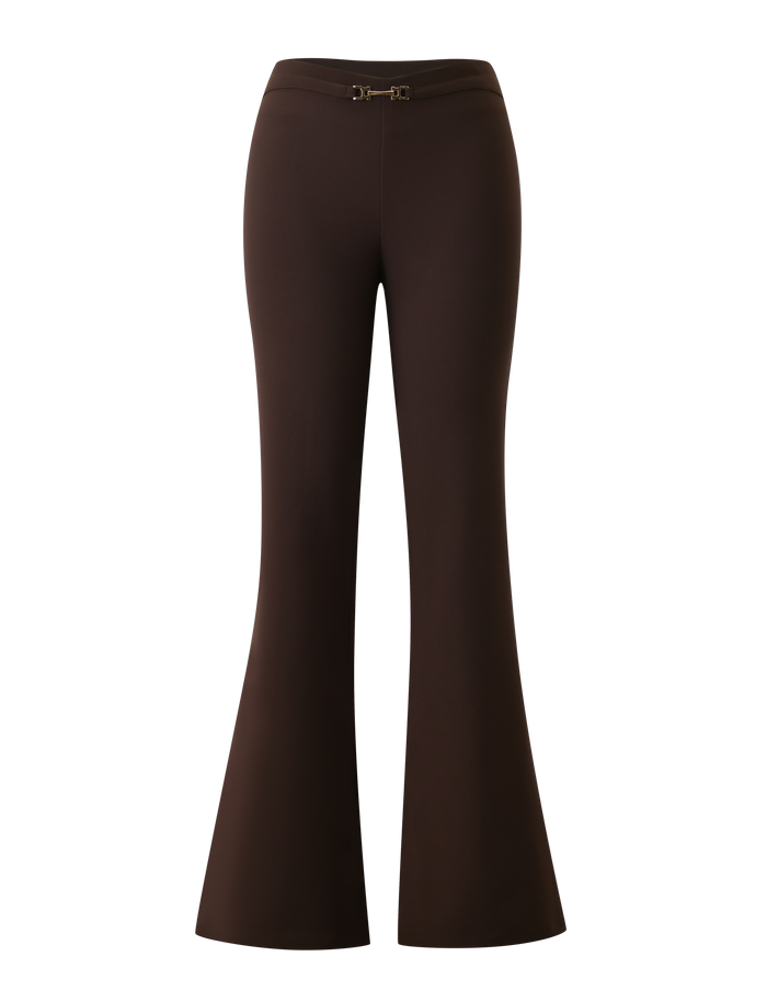 The TIGERMIST KITTIE BUCKLE PANT - CHOCOLATE features high-waisted, flared legs in stretch suiting fabric, a fitted waist, slight hem flare, and a small gold front buckle, shown against a plain white background.