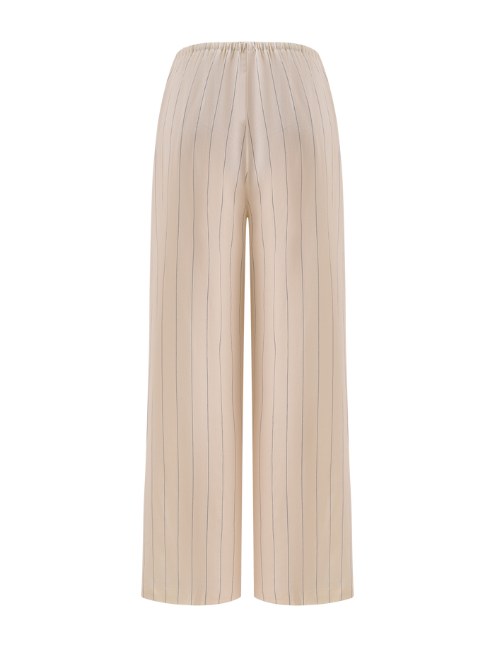 The LAINEY PANT - BEIGE STRIPE by TIGERMIST features beige wide-leg linen pants with thin vertical black pinstripes and an elastic waistband, shown against a plain white background.