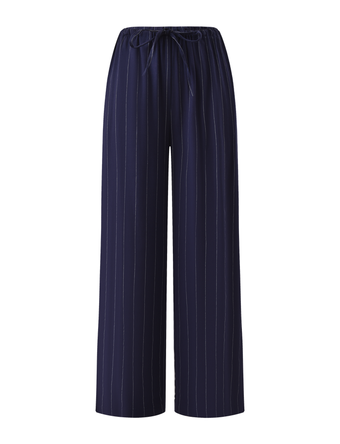 The TIGERMIST LAINEY PANT - NAVY PINSTRIPE features wide-leg linen in navy with thin white pinstripes, an elasticated waist, and a drawstring tie, shown against a plain white background.