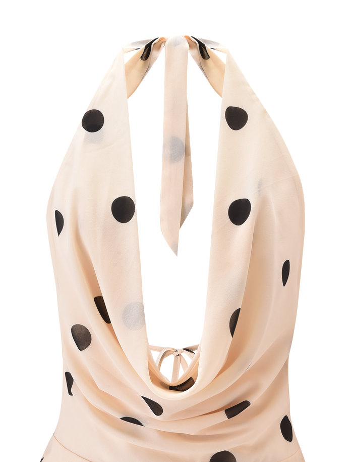 The LATHAN MINI DRESS - CREAM by TIGERMIST is a chic chiffon halter mini with large black polka dots, a dramatic draped cowl back, and neck tie straps—playful elegance in light beige.