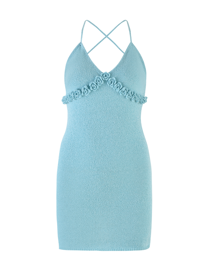 The TIGERMIST LAVELLE MINI DRESS - BLUE is a light blue, sleeveless bodycon mini dress with textured fabric, thin criss cross straps, and floral appliqué detail below the bust for a chic touch.
