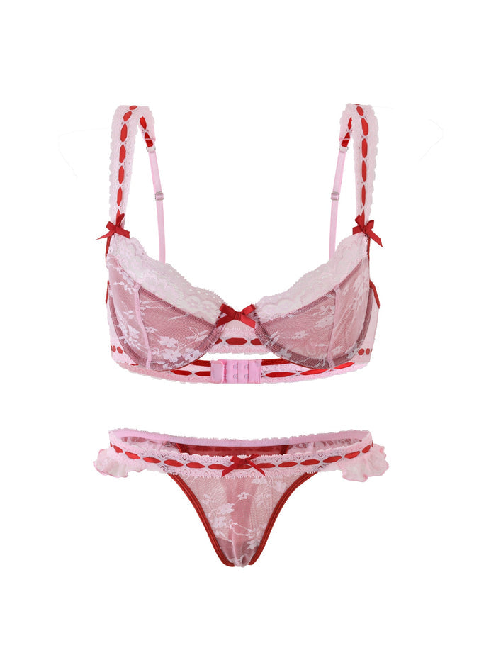 The LAVINA SET - RED : SALSA from TIGERMIST is a red and pink lace lingerie set, featuring a bra with decorative bows and adjustable straps. It comes paired with matching panties that have similar lace detailing and side cutouts. The lingerie boasts a floral pattern and is displayed against a white background.