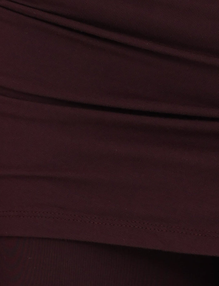 Close-up view of the LEILANI PANT - BROWN : CHOCOLATE from TIGERMIST, showcasing a gathered and layered texture in a dark brown hue. The high-stretch fabric appears soft and pliable, with visible stitching along the lower edge.