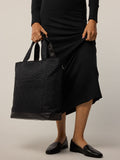 Greyson Clothiers Leland Tote in black quilted signature pattern - On Model Hand Carry View | Greyson Clothiers