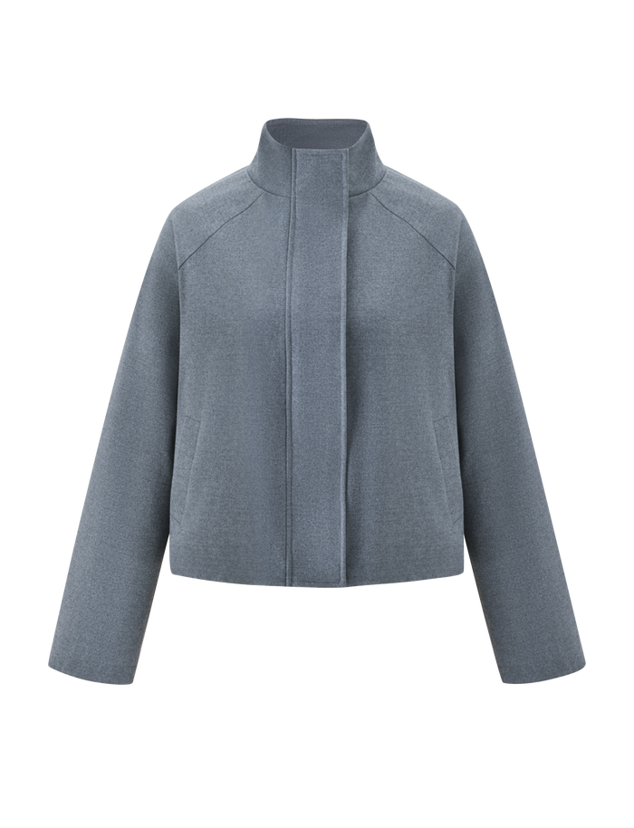 The TIGERMIST LENNEX JACKET in heather charcoal is a minimalist, oversized light wool piece with a mock neck collar, long sleeves, and concealed front closure, shown against a plain white background.