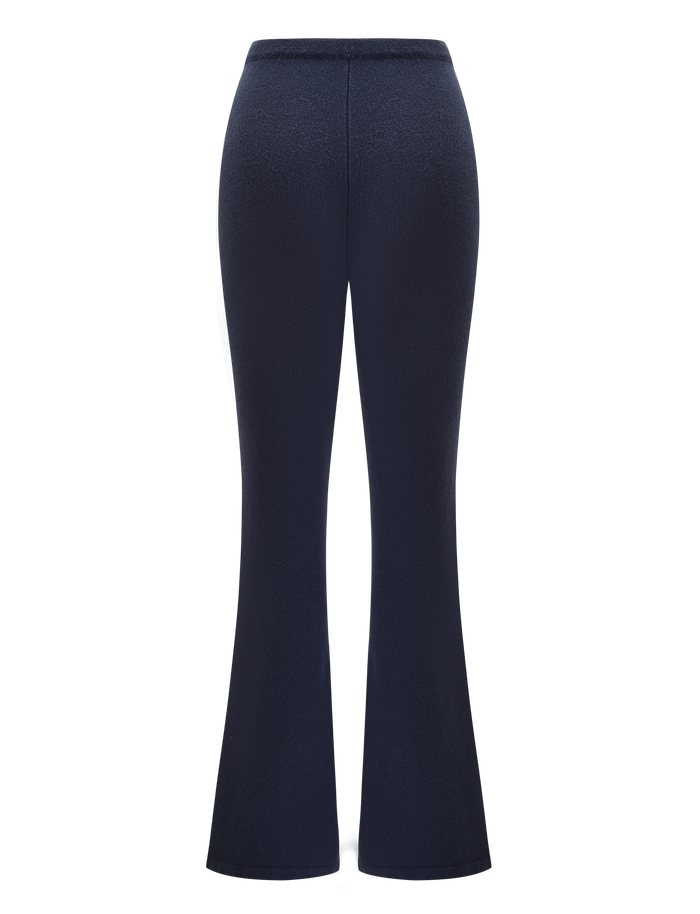 Back view of TIGERMIST's LEORA PANT in navy, showcasing a high-waisted, relaxed fit and flared silhouette against a plain white background.