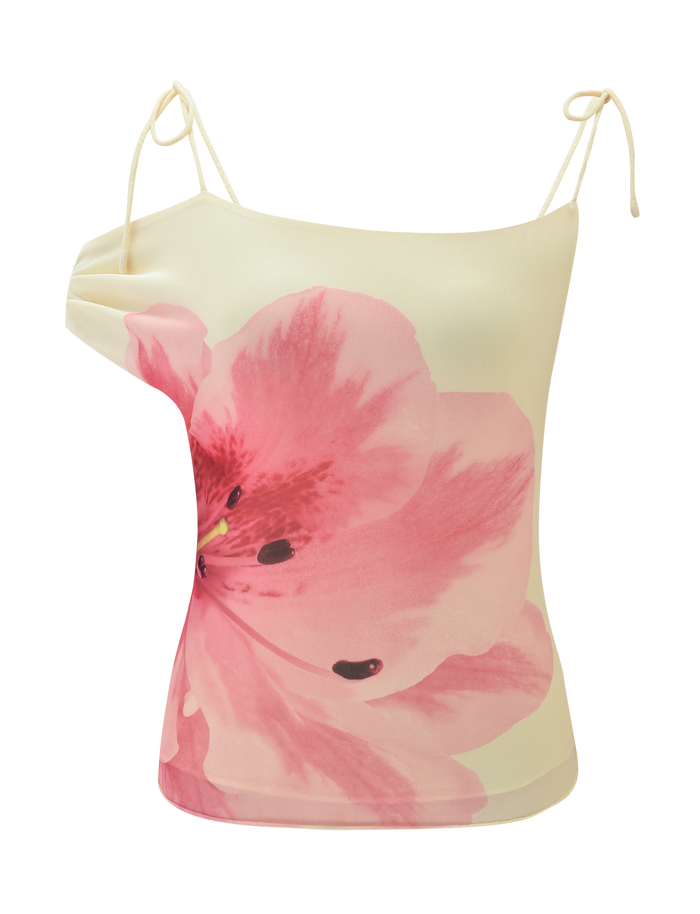 The LILLIAN TOP by TIGERMIST is a yellow off-shoulder top with thin straps, featuring a bold pink floral design on the front.