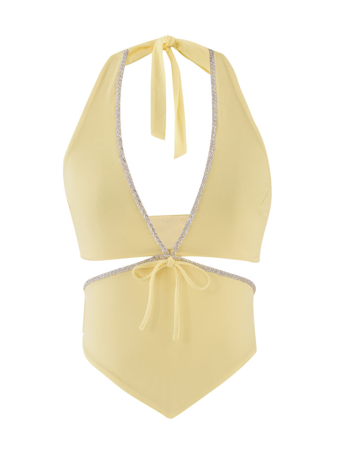 The LIZZIE TOP - LEMON by TIGERMIST is a light yellow halter-style swim top with a deep V neckline, cut-out details, silver trim accents, and adjustable bow ties at the neck and waist.