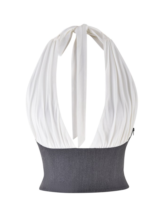 The TIGERMIST LOTUS TOP - CREAM : GREY is a cropped halter top featuring a white gathered bodice, wide dark grey ribbed waistband, soft jersey fabric, neck tie with back bow, and an open-back design.