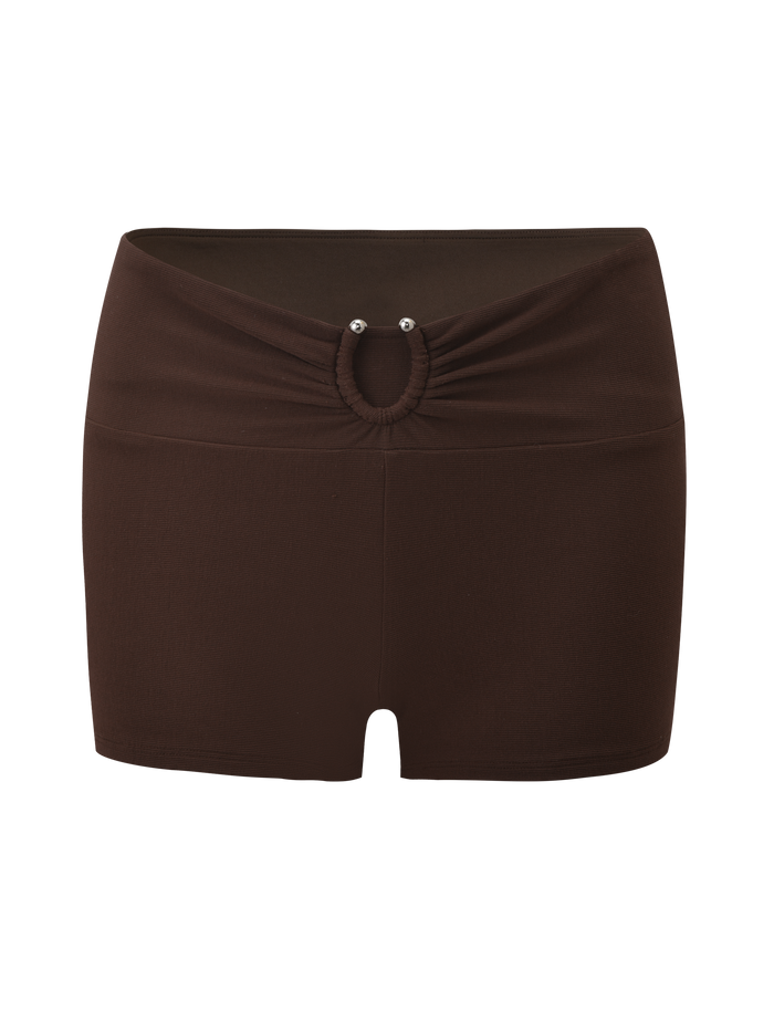 The TIGERMIST LUNARA SHORT - CHOCOLATE is a pair of mini shorts with a gathered waistband, ruched front, and a small circular cutout accented by two metallic studs.