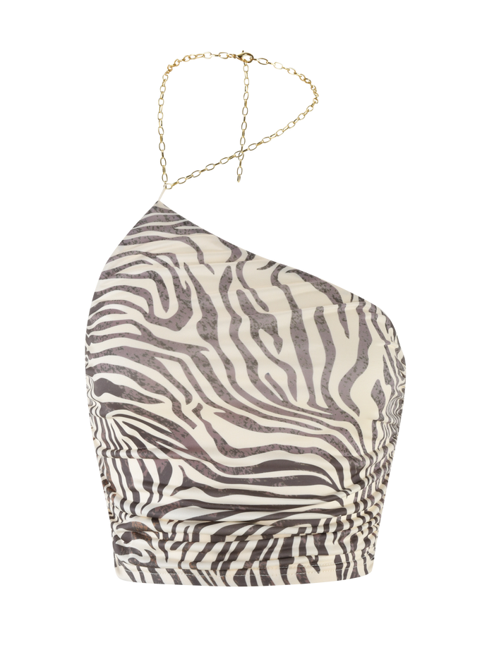 The LYRA TOP - NEUTRAL : ZEBRA by TIGERMIST is an asymmetric one shoulder, zebra print top with a ruched design, thin gold chain strap, and cropped length for a bold, modern style.