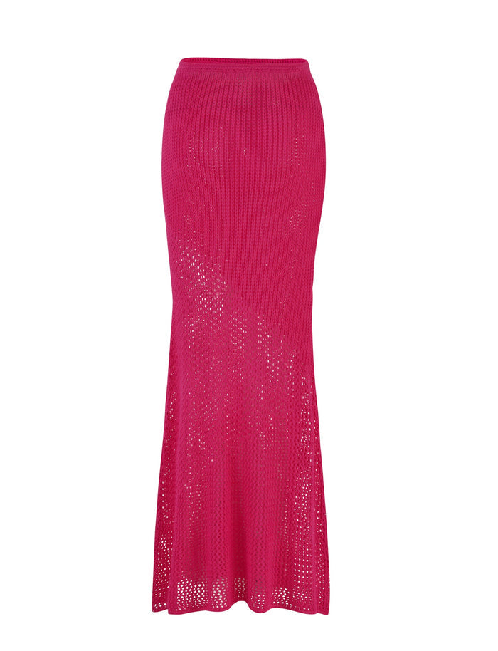 The MACAULEY SKIRT - PINK : HOT PINK by TIGERMIST is an ankle-length, crochet piece in a vibrant hot pink hue. It features a bodycon silhouette that flares slightly towards the hem, adorned with a delicate patchwork crochet pattern adding both texture and a semi-sheer appearance.