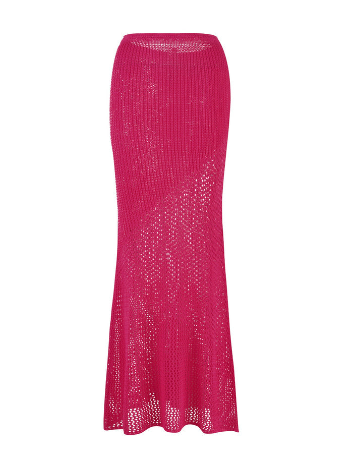 The MACAULEY SKIRT - PINK : HOT PINK by TIGERMIST is a long, vibrant pink skirt featuring an intricate patchwork crochet pattern with delicate holes and a slightly flared hem for a lightweight, airy look. The design is fitted at the waist and hips, tapering towards the bottom for a stylish bodycon silhouette.