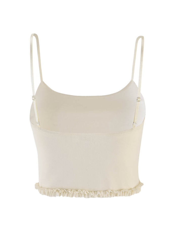 The TIGERMIST MAISIE TOP in pale yellow is a cropped camisole with mesh fabric, thin adjustable straps, and a ruffled hem, shown on a plain white background.
