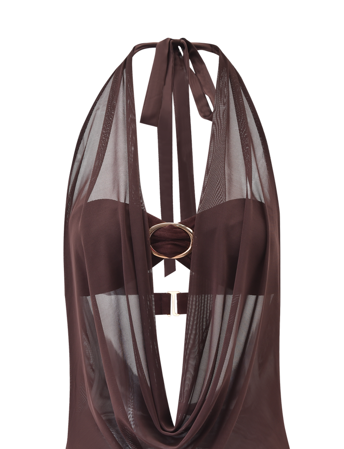 The MAKENA TWO-PIECE DRESS in Chocolate by TIGERMIST features a stylish cowl neckline, sheer mesh panels, a central gold ring detail, and neck ties for a modern look that blends opaque and transparent fabrics.