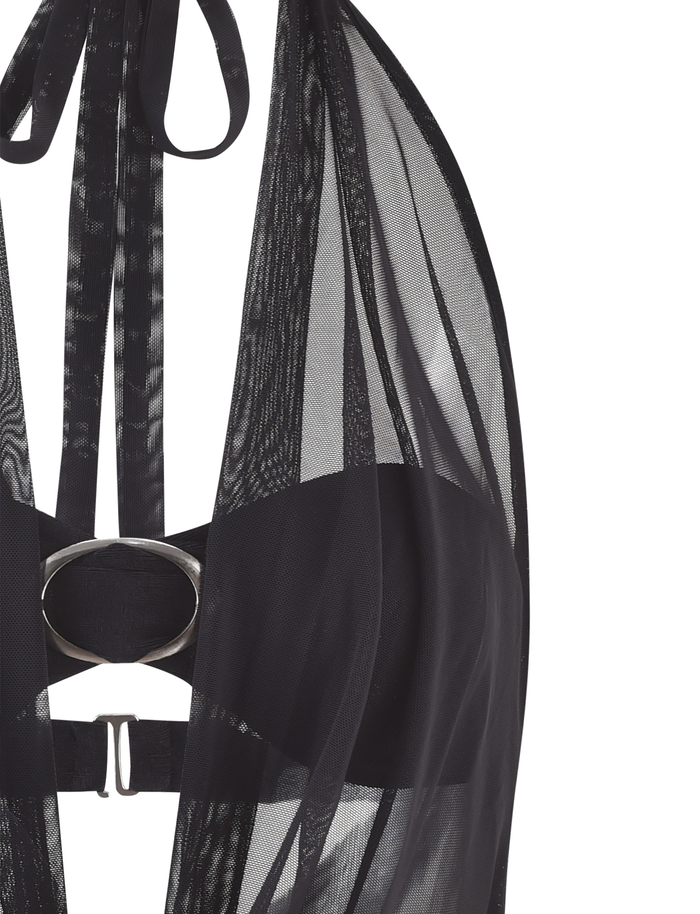 Close-up of the TIGERMIST MAKENA TWO-PIECE TOP in black, featuring a halter-style sheer mesh design, solid underbust band, metallic oval center detail, and visible ties and straps against a light background.