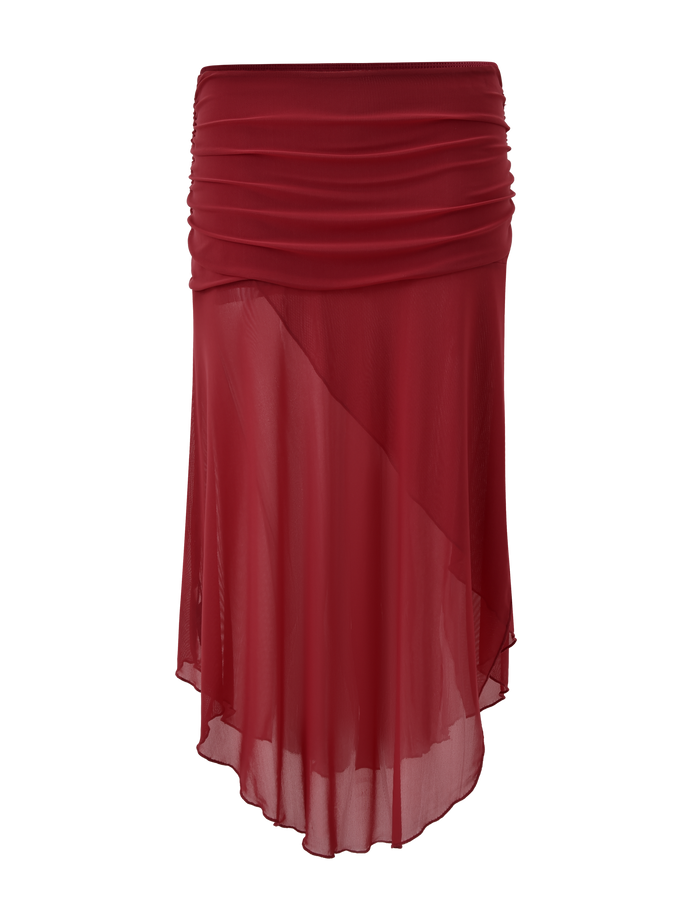 The TIGERMIST MARIANA SKIRT - RED is a sheer, knee-length skirt with a ruched waistband and asymmetric wrap silhouette, crafted from lightweight, flowy fabric.