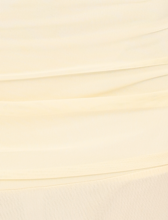 Close-up of the MARIANA SKIRT in pale yellow by TIGERMIST, featuring soft, high-stretch fabric with a textured mesh-like pattern and gentle horizontal folds.