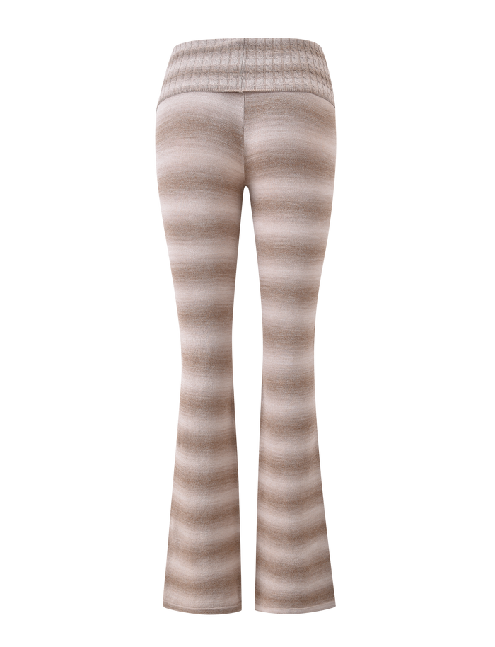 The MARISSA FOLDOVER KNIT PANT - TAUPE OMBRE STRIPE by TIGERMIST features beige and light brown stripes, a flared leg, and a wide ribbed foldover waistband, shown from the back on a plain white background.