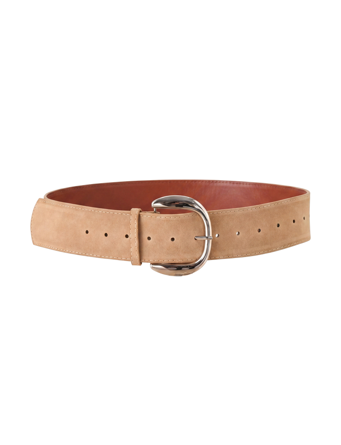 The TIGERMIST MARTINA BELT - TAN is crafted from faux suede with a large silver buckle, multiple adjustment holes, and a smooth texture. It features a reddish-brown inner lining and is shown against a white background.