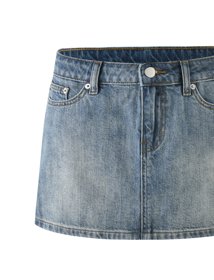 The TIGERMIST MICHAYLA MINI SKIRT - MID WASH is a blue rigid denim mini with front button and zipper closure, five-pocket styling, visible front pockets, and subtle faded detailing.
