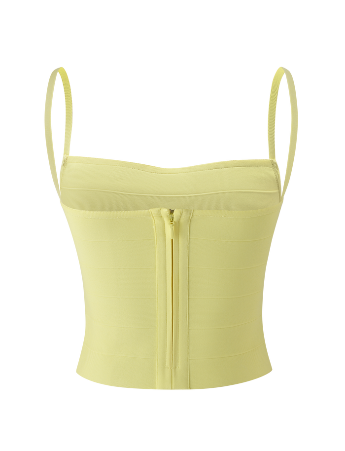 The MIDORI BANDAGE TOP by TIGERMIST is a light yellow fitted top with thin adjustable straps, a straight neckline, and a back zipper. Its structured fabric features horizontal panel detailing for added style.
