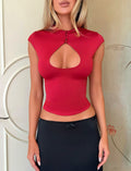A woman wears the Tiger Mist USA CL - MILLS TOP, a form-fitting red top with a keyhole cutout, paired with a black skirt while standing indoors against a light-colored background. Her face is partially out of frame.