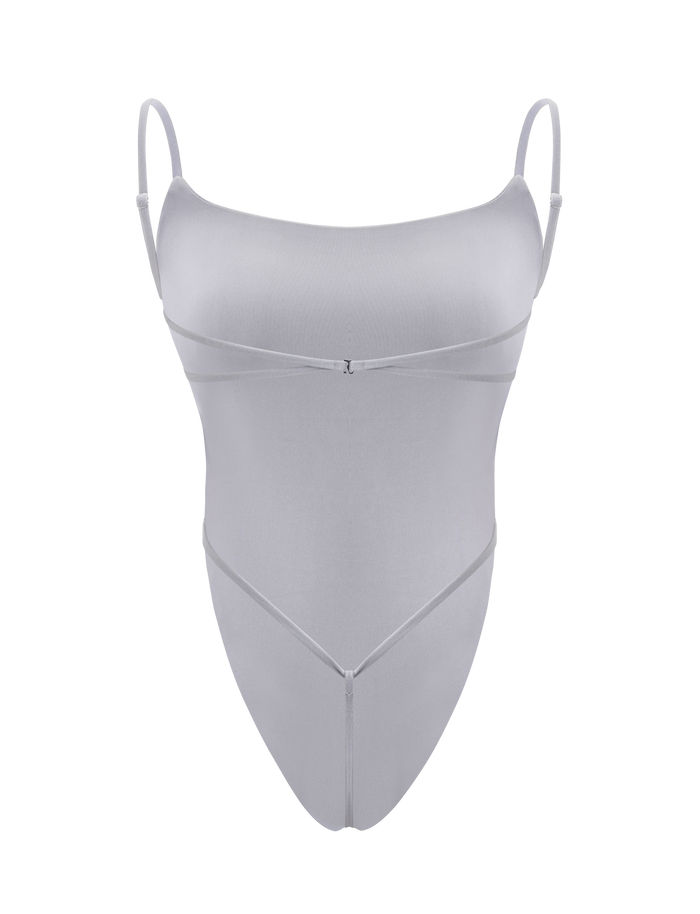 The TIGERMIST MINERVA BODYSUIT - FROST GREY features spaghetti straps, a scoop neckline, and thin decorative straps crossing under the bust and waist. This bodycon style is shown against a plain white background.