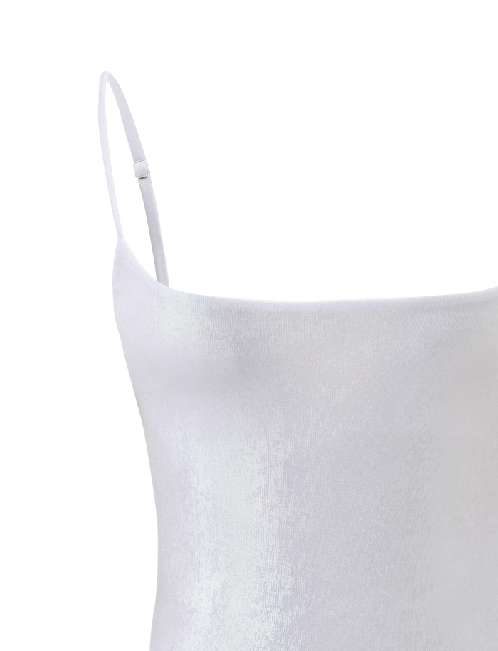 Close-up of the MINERVA BODYSUIT - PEARL by TIGERMIST, a minimalist white spaghetti strap bodysuit with a subtle sheen, straight neckline, and simple design set against a plain white background.