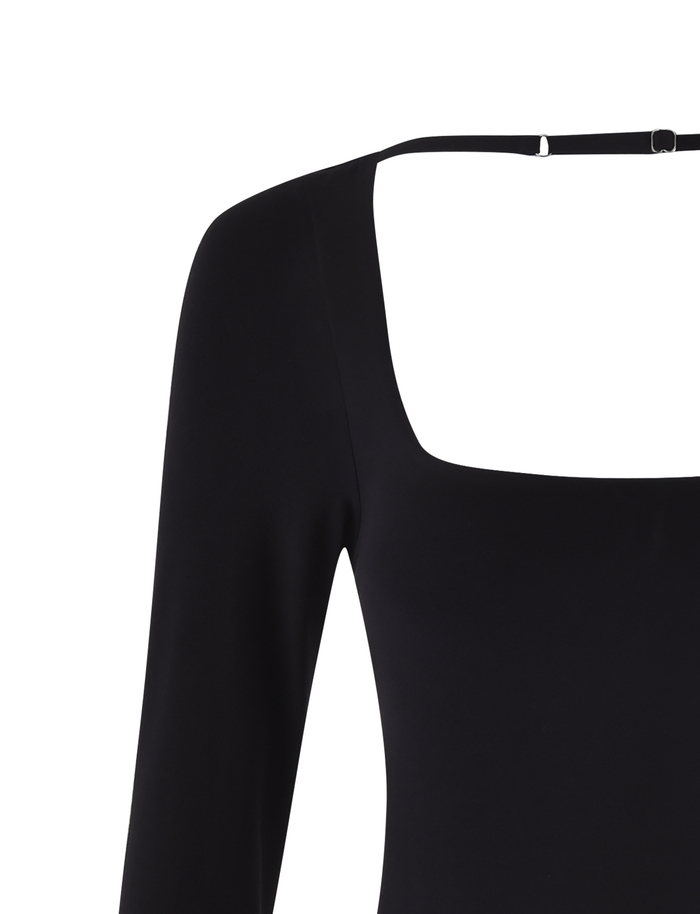 A close-up of TIGERMIST’s MINERVA LONG SLEEVE BODYSUIT - BLACK shows its bodycon fit, wide square neckline, thin upper back strap, and sleek long sleeve design.