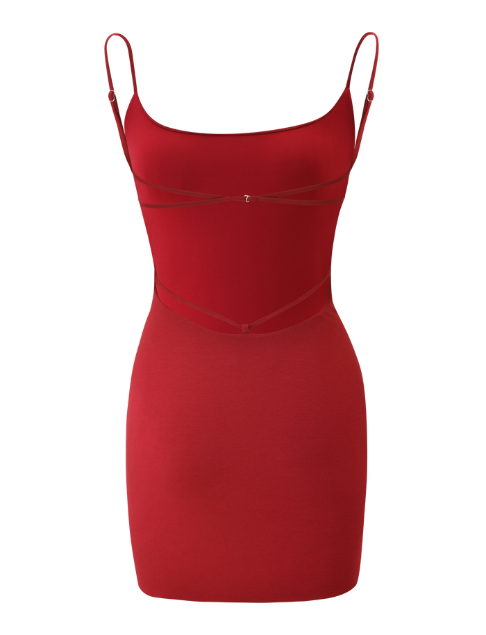 The MINERVA MINI DRESS by TIGERMIST is a sleeveless, form-fitting red bodycon dress with thin adjustable straps and subtle strap details on the chest and waist, shown against a white background.