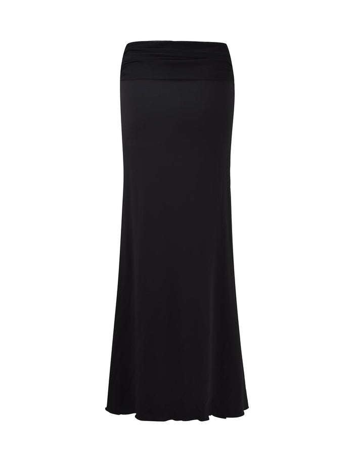 The long MIST SKIRT - BLACK from TIGERMIST is displayed against a white background. The skirt is fitted at the waist and hips, flaring out slightly towards the bottom for a flowing silhouette. The fabric appears smooth and slightly stretchy, without any visible patterns or embellishments.