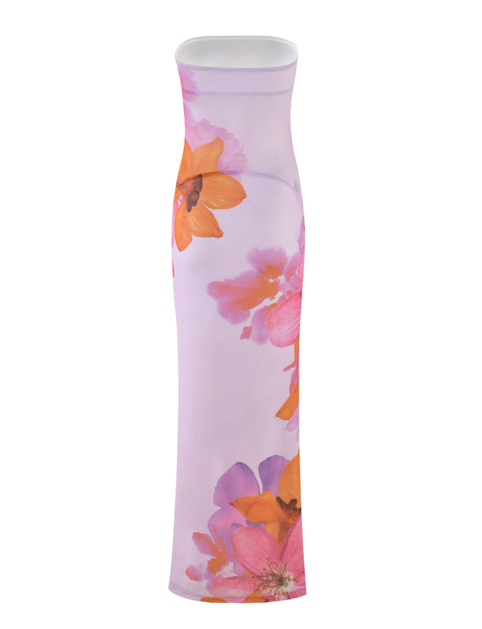 The TIGERMIST MORGAN DRESS - PINK: BY POPPY SUMMER features a strapless, floor-length design with a stunning light purple base adorned with vibrant floral prints of large orange and pink flowers. The slim, bodycon silhouette of this elegant dress highlights the impeccable Tiger Mist x By Poppy craftsmanship.