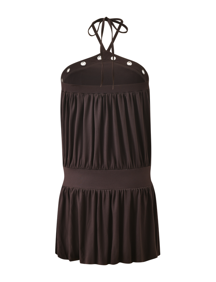 The TIGERMIST NATASHA DRESS in chocolate is a mini halter dress featuring an empire waist, grommet details on the neckline, gathered buttery soft jersey fabric, and a tiered flared skirt. Shown against a plain white background.
