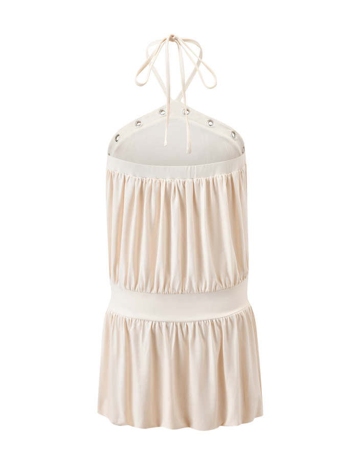 The NATASHA DRESS in cream by TIGERMIST features a sleeveless halter style with a gathered, ruched design, open back, metal grommet accents at the neckline, and chic, softly shiny fabric.