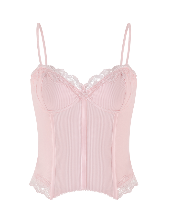 The TIGERMIST NILA CORSET TOP in soft pink features adjustable spaghetti straps, lace trim at the neckline and hem, a fitted bodice with vertical seam detailing, and is crafted from a soft, delicate fabric.