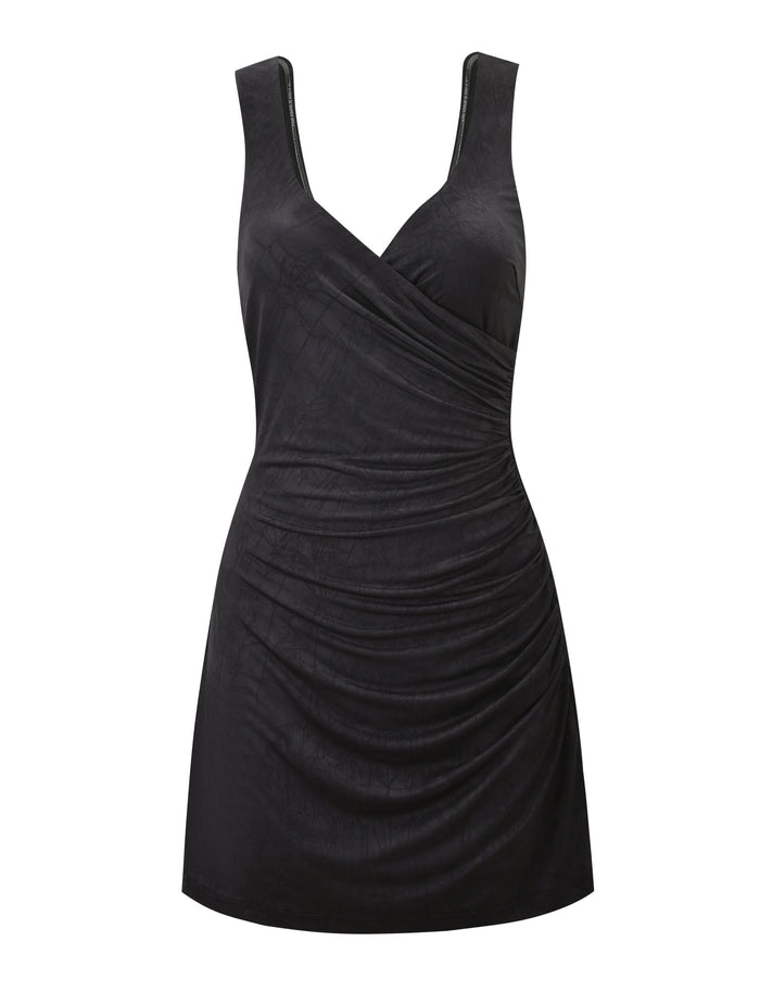 The TIGERMIST NURA MINI DRESS in black is a sleeveless mini dress with a V-neck, wrap-style front, ruched side detailing, and an open back.