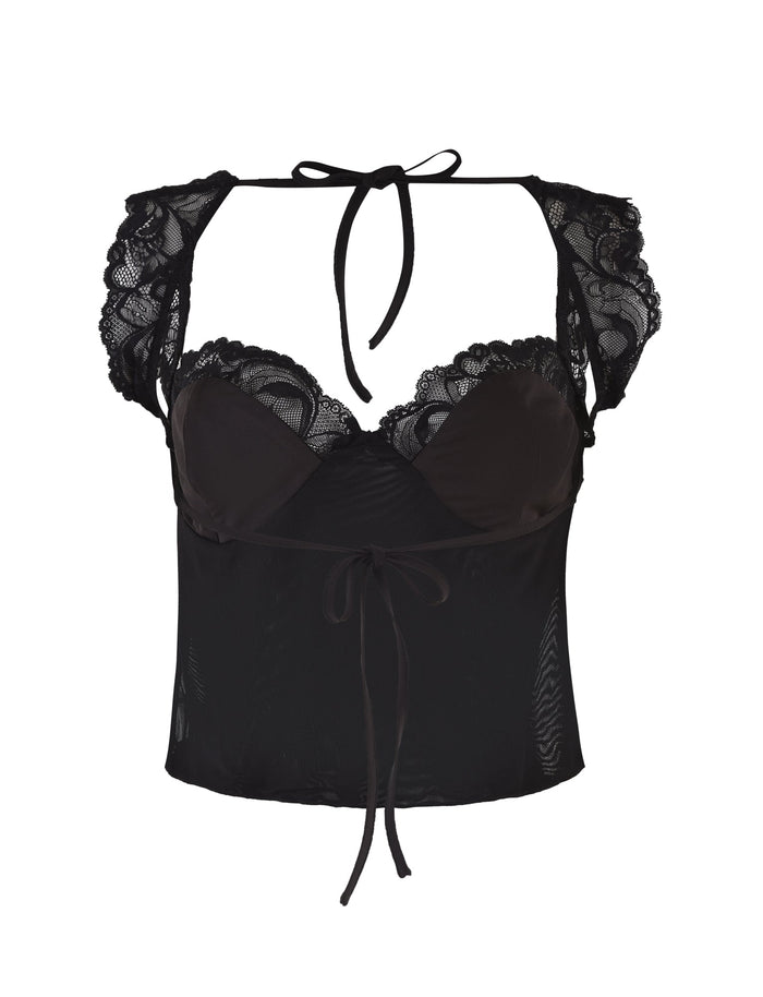 The NYOMI TOP - BLACK by TIGERMIST is a black lace crop top featuring sheer panels and cap sleeves. Its open back design is enhanced with delicate lace detailing around the neckline and shoulders. The adjustable ties at the front and back add a feminine and stylish touch.